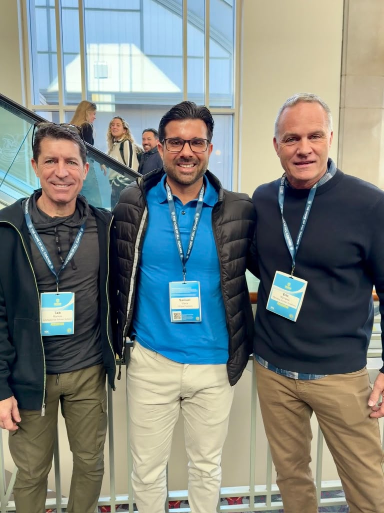 Sam Viana with two youth soccer coaches at a conference